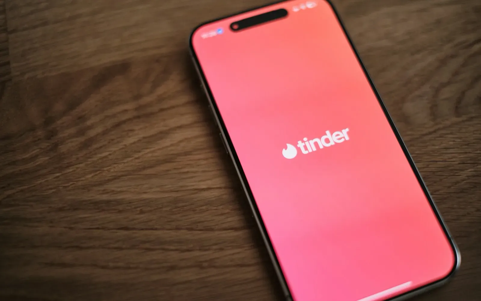 Smartphone mit geöffneter Dating-App auf einem Holztisch – Trans Dating App im Vergleich